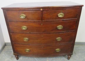 A George III mahogany bow-fronted chest of two short over three long graduated cock-beaded drawers