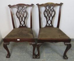 A pair of Chippendale Revival mahogany side chairs, having carved and pierced backs above drop-in