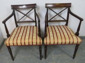 A pair of Regency Period mahogany elbow chairs, the backs with X stretchers, joined with reeded arms