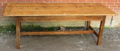 An antique pine farmhouse kitchen table, of good colour and patina, on square supports with side
