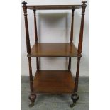 A Victorian mahogany three tier freestanding whatnot, having onion finials and turned uprights, on