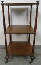 A Victorian mahogany three tier freestanding whatnot, having onion finials and turned uprights, on