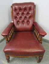 A late Victorian mahogany library chair, having scrolled back and turned spindles, re-upholstered in