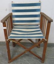 A teak framed folding director’s chair, having blue and white striped canvas seat material. H85cm