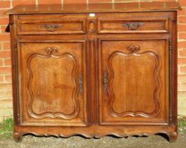 An 18th century and later French fruitwood sideboard, housing two short drawers above cupboards with