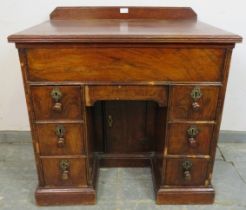 An 18th century and later walnut and oak ladies’ kneehole desk, housing central blind drawer above a