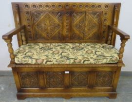 A good quality medium oak monk’s bench in the 17th century taste, the box base with diamond carved