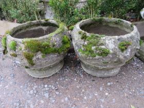 A pair of nicely weathered reconstituted stone garden planters having relief moulded decoration,