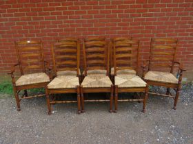 A set of eight (6+2) Lancashire ladderback oak dining chairs, with rush seats, on turned supports