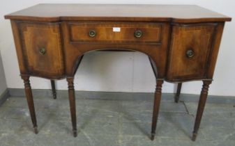A vintage mahogany reverse breakfront sideboard in the Regency taste, crossbanded and strung with