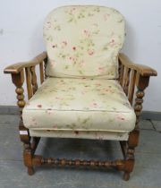 An antique Continental beech and ash wheelback reclining armchair, having carved and pierced sides