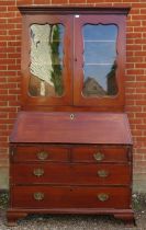 A Georgian mahogany bureau bookcase, the top section with two height-adjustable