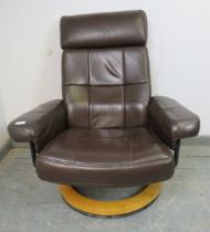 An Ekornes style relining and swivel lounge chair upholstered in brown leather, on a bentwood