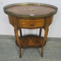 A 19th century French tulipwood and kingwood crossbanded oval two-tier table, having profuse