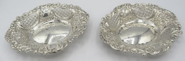 A pair of oval silver bon bon dishes with flower, scroll and pierced decoration, Chester 1897.