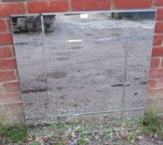 A large contemporary square wall mirror with sectioned and bevelled plates. H80cm W80cm (approx).