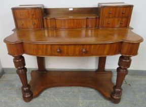 A Victorian mahogany writing desk, the upper gallery with central lidded compartment flanked by four