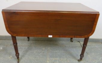 A late Georgian mahogany Pembroke table, crossbanded and strung with ebony, having single drawer