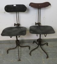 A pair of early 20th century height-adjustable machinist’s stools, also having height-adjustable