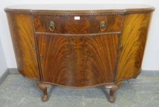 A good quality antique flame mahogany serpentine fronted sideboard in the Georgian taste, housing