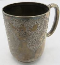 A silver christening mug with 'C' shaped handle and foliate engraved decoration, monogrammed,