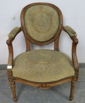 An 18th century French fruitwood open-sided armchair, having scrolled and reeded arms, on tapering