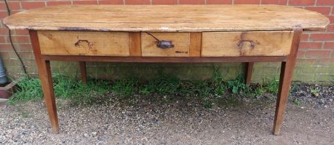 A rustic antique French chestnut farmhouse table, having three drawers to one side with cast iron