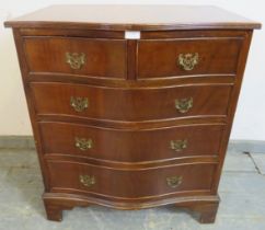 A reproduction mahogany serpentine chest in the Georgian taste, having two short and three long