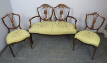 An Edwardian mahogany three-piece suite comprising an open sided sofa and two chairs, the pierced