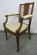 An Edwardian mahogany elbow chair strung with boxwood, having marquetry inlaid and pierced