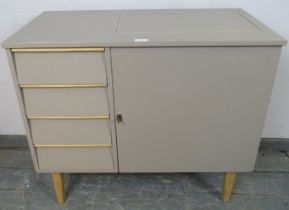 A mid-century sewing table painted grey, the louvred front enclosing four blind drawers, opposite