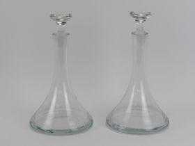 A pair of clear glass decanters, 20th century. Of plain conical form. (2 items) 30.8 cm height, 30.4