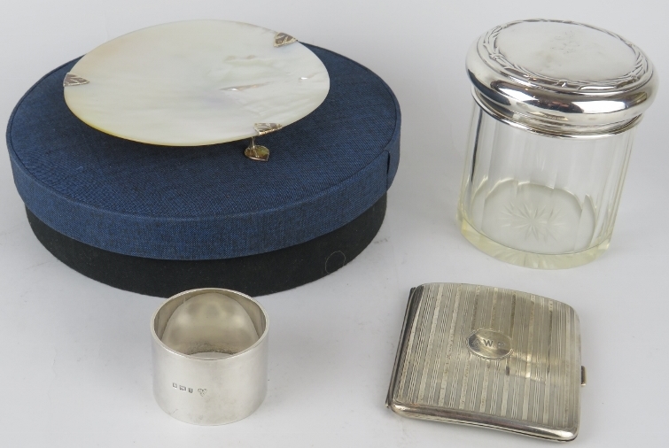 A 1918 hallmarked silver cigarette case, a silver topped jar, silver napkin ring and a boxed