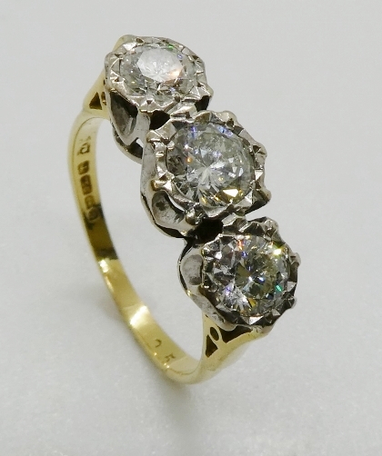 A three stone diamond ring, the graduated round brilliant cut diamonds illusion set in platinum - Image 2 of 4