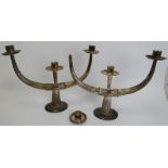 A pair of Eastern white metal candelabra each with triple sconces. Engraved decoration throughout