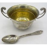 A silver porringer with gilded interior and matching silver spoon. Engraved on the side, London