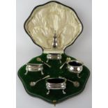 A boxed harlequin cruet set containing four salts, four spoons and a pepperette. One salt and two