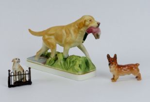 A Royal Worcester porcelain’ Yellow Labrador’ by Doris Lindner and two miniature dog figurines.