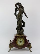 A French gilt metal mounted red marble mantle clock, late 19th/early 20th century. Mounted with a