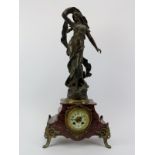 A French gilt metal mounted red marble mantle clock, late 19th/early 20th century. Mounted with a