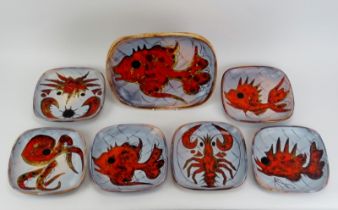 A set of six Vallauris pottery plates and a matching tray, mid 20th century. Incised and glazed