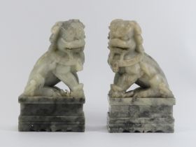 A pair of Chinese carved soapstone Buddhistic temple lions on plinths, 20th century. (2 items) 25 cm