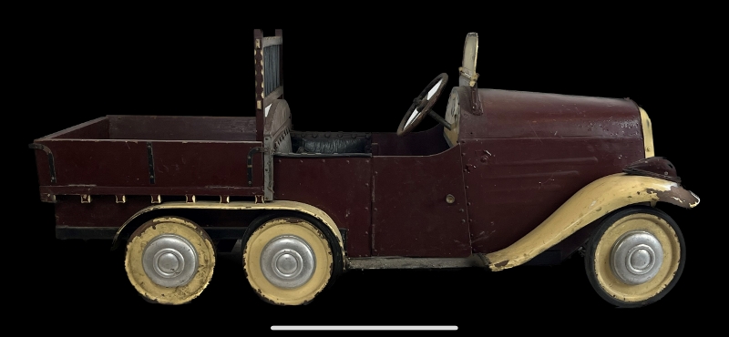 Toys: A vintage children’s pedal car, mid 20th century. The car was likely to have been produced