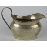 A silver Georgian style cream jug, hallmarked for Chester, maker and date letter rubbed. Height 8cm.