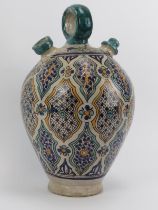 A large Moroccan tin glazed pottery water decanter jug. Modelled with a loop handle and two