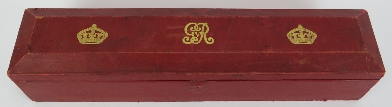 A George V red leather scroll box with gilt embossed royal cipher and crowns. 48.6 cm length.