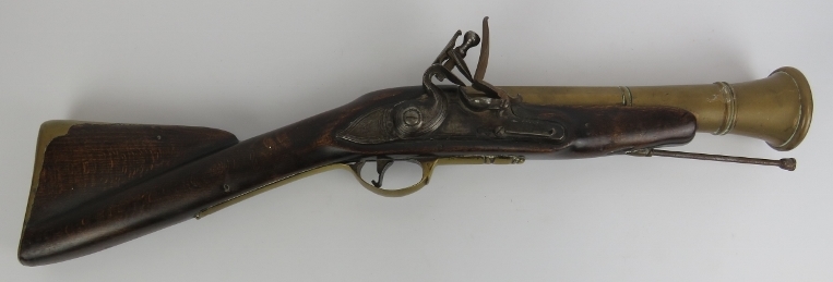 An oak, brass and steel flintlock blunderbuss, 18th century. With a three-stage brass barrel and