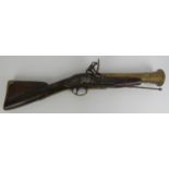 An oak, brass and steel flintlock blunderbuss, 18th century. With a three-stage brass barrel and