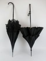 Two late Victorian/Edwardian black silk and lace parasol umbrellas. (2 items) 96.8 cm length, 93.7