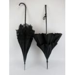 Two late Victorian/Edwardian black silk and lace parasol umbrellas. (2 items) 96.8 cm length, 93.7